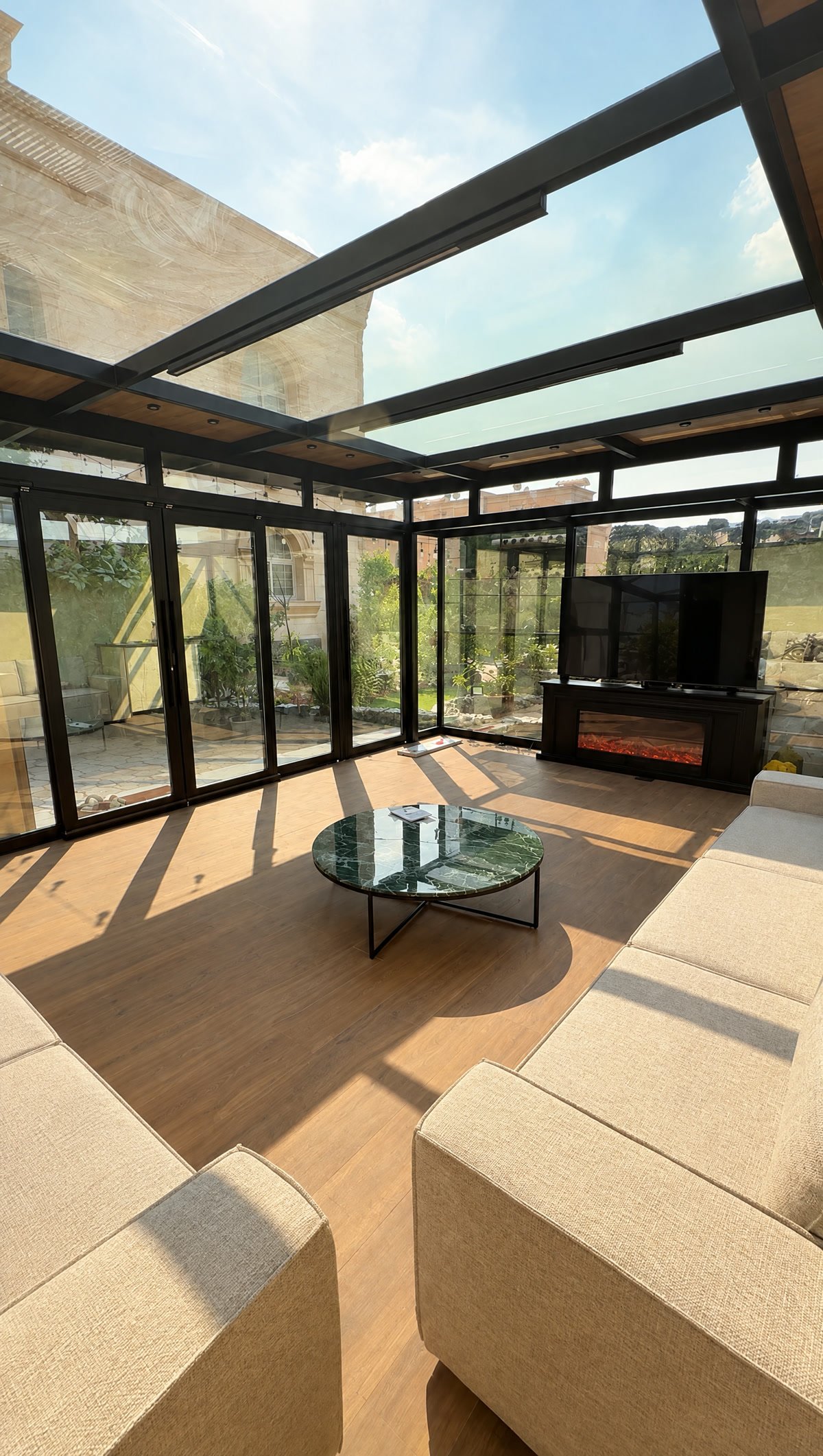 Glass room in the afternoon with sunlight through the glass roof across the floor
